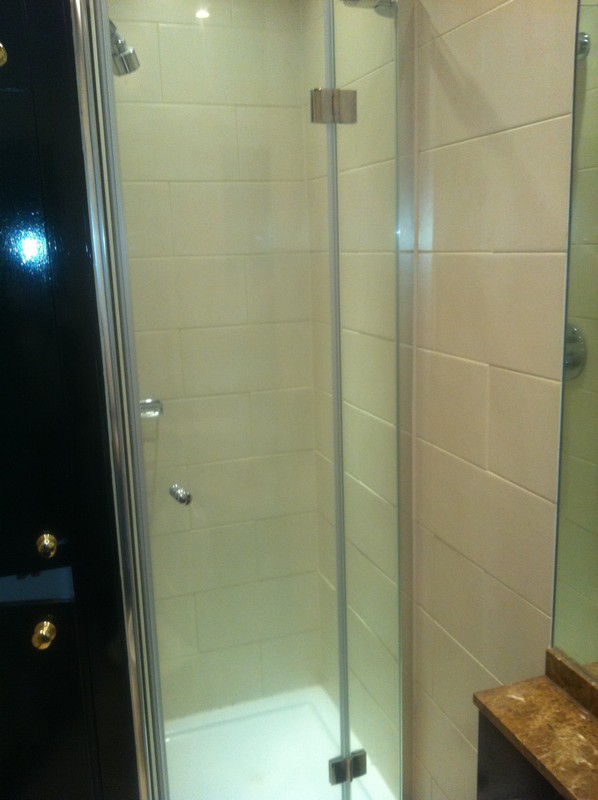 Frameless glass shower enclosure with chrome fittings in Maida Vale