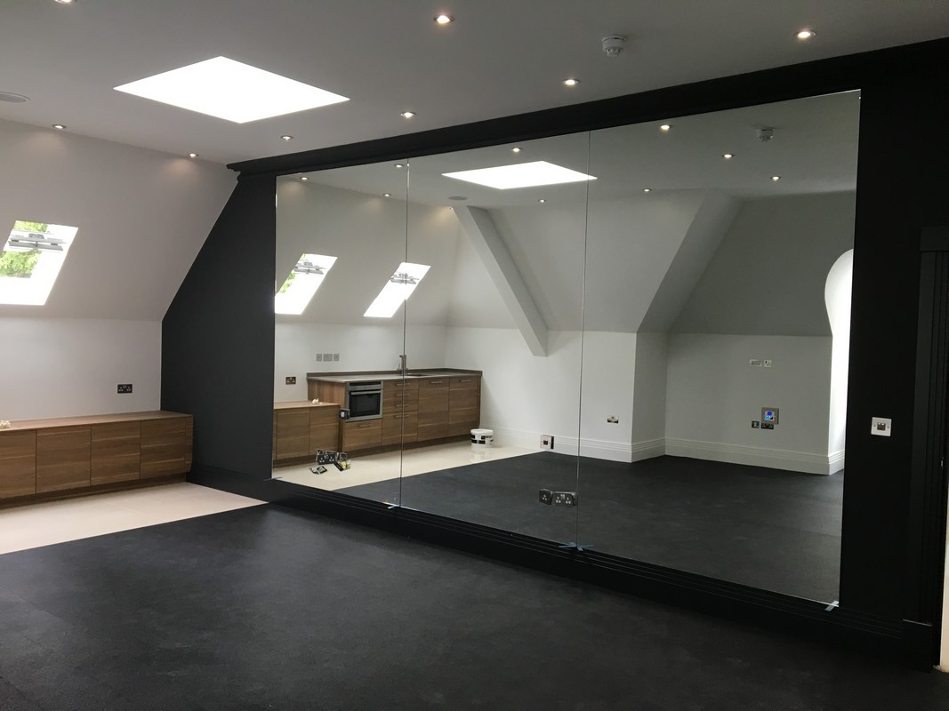 Frameless glass wall dividing loft conversion in Maida Vale