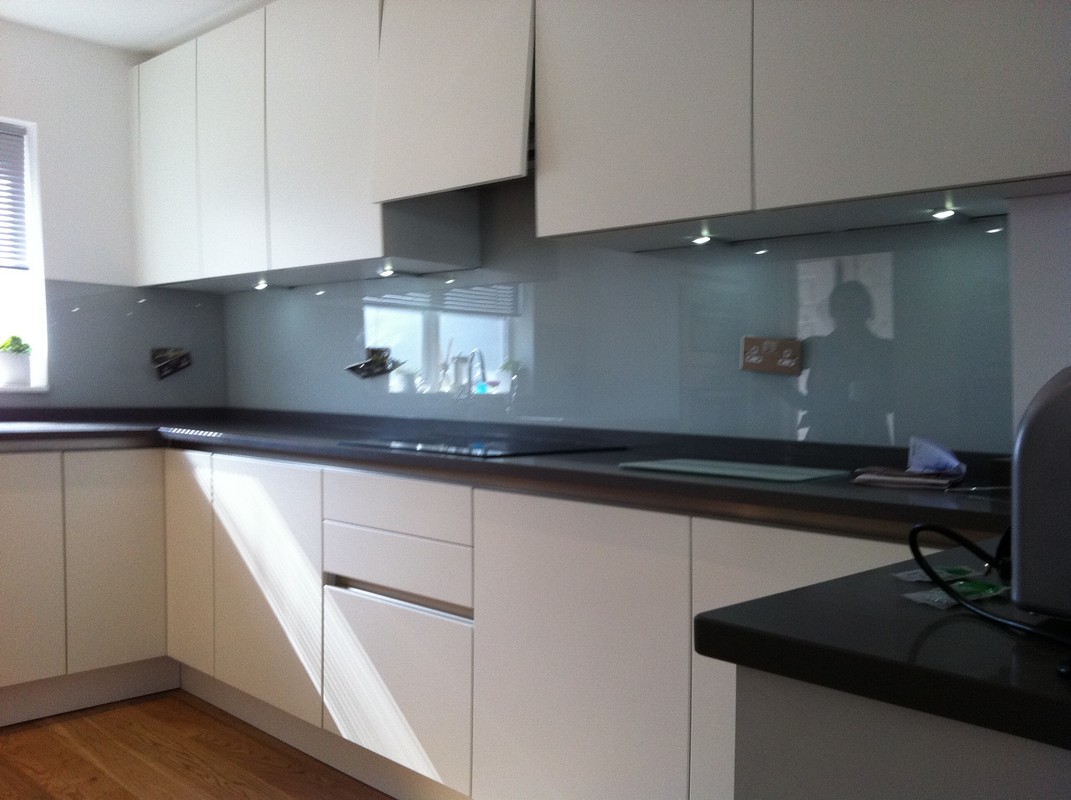 Grey glass kitchen splashback with LED lighting in Maida Vale